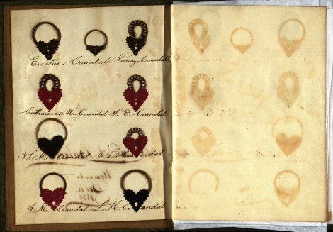 The placement of the hair locks resembles a family tree, with Ann's father and mother at the top and her siblings below. Note the "ghost" images--remnants from the oils in the hair--on the opposite page.